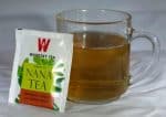 Tea bag packet and cup of tea